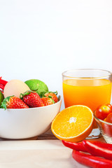 Healthy concept with mixed fruits and vegetables on wooden background