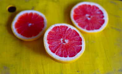 bright red grapefruit on yellow background