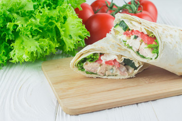 chicken shawarma and vegetables, on a wooden background