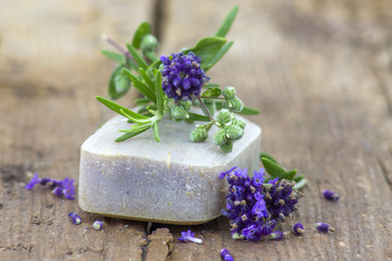 Obraz na płótnie Canvas bar of natural soap and lavender flowers