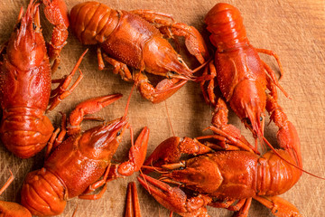 red boiled crawfish on wooden desk cutting board background texture food and drinks sea products concept with empty space for copy or text