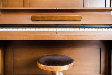 Old wooden vintage piano keys on wooden musical instrument in front view © annebel146
