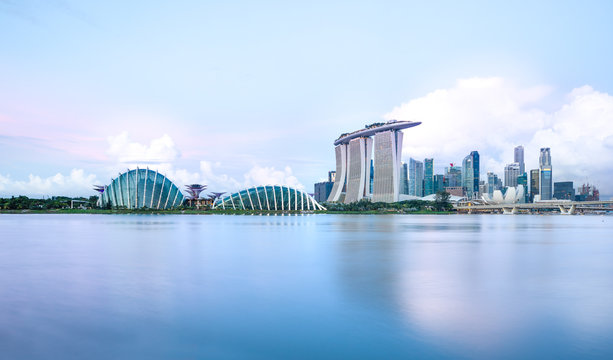 Sun rising over the downtown skyline of Singapore as viewed from across the water from The Garden East. Singapore.