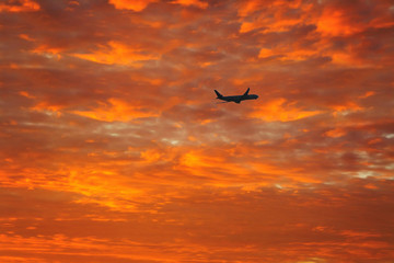 Fototapeta na wymiar silhouette of airplane on the sunset sky. Canary Islands at sunset. La Gomera