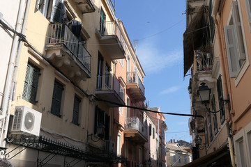 Fototapeta na wymiar Cityscape of old town part of Corfu town (Greece) with its typical facades and powerlines.