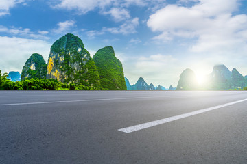 The empty asphalt road square and natural landscape under the blue sky