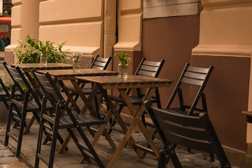 Chairs and table in the street. Cozy cafe.
