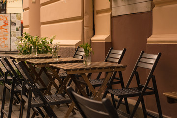 Chairs and table in the street. Cozy cafe.