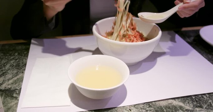 Woman enjoy Chinese ramen in restaurant