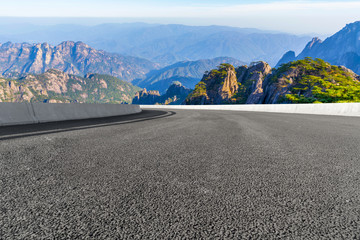 The empty asphalt road square and natural landscape under the blue sky