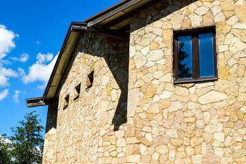 New stylish country house. Building with Windows made of natural stone.