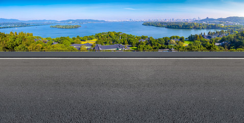 Asphalt road square and river hill under the blue sky