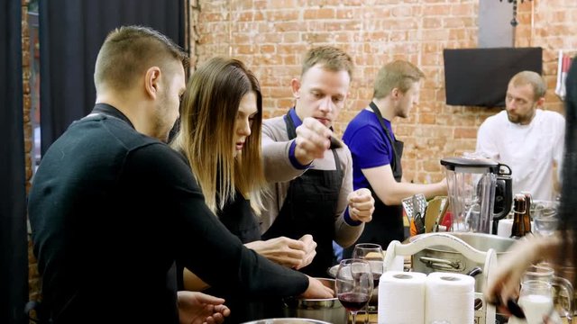 A group of people preparing mussels with cream at the cooking master class. 4K