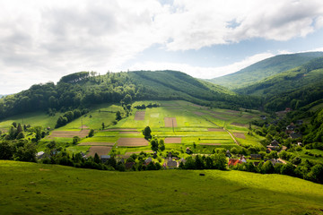 Beautiful Ukraine landscape, village in the valley with fileds