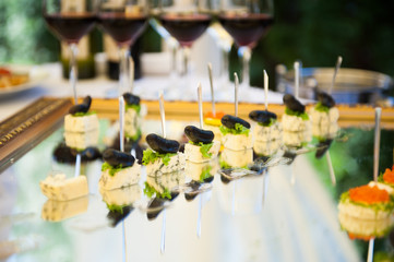 Delicious snacks on wedding reception table in luxury outdoor restaurant