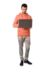 Full body of  Man in a pink sweatshirt with laptop