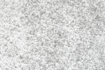 Rough Concrete Wall Decoration, Painted White. White Concrete Wall with Many Protruding Stones.