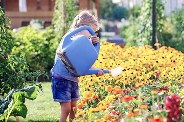 Child is watering flowers