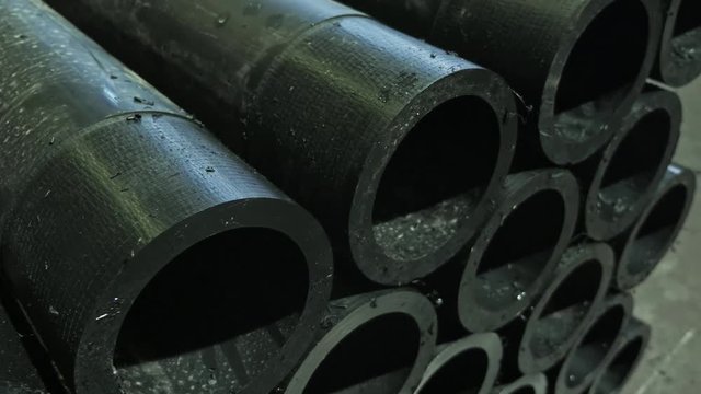 Sawmill circular saw machine. Manufacture of plastic water pipes to the factory. Process of making plastic tubes on the machine tool with the use of water and air pressure.