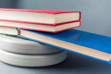 Multicolored books lie on gray pancakes from a sports bar
