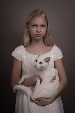 Serious girl holding cat