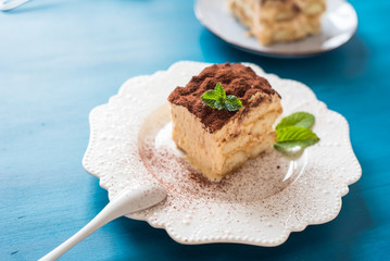 Italian tiramisu dessert on a porcelain plate