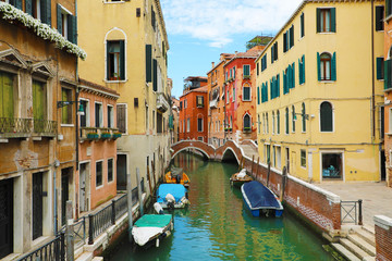 Picturesque view of Venice Canal with bridges and boats. Venice is a popular tourist destination of Europe in Northen Italy.