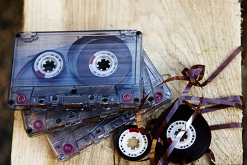 Old audio cassettes on a wooden close-up background