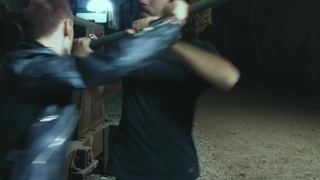 two men fighting in an abandoned place. Violence, struggle