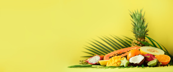 Assortment of exotic fruits on yellow background. Banner. Detox, vegan food, summer concept....