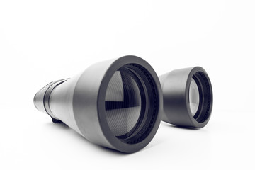 Close Up Of Black Binoculars With Big Reflective Lenses On Plain White Background