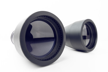 Close Up Of Black Binoculars With Big Reflective Lenses On Plain White Background