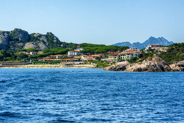 Fototapeta premium A view from the mediterranean sea of the small town of Baia Sardinia in Sardinia Italy