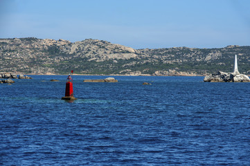 A close-up of two nautical light with the coast in the background, Sardinia mediterranean sea in Italy