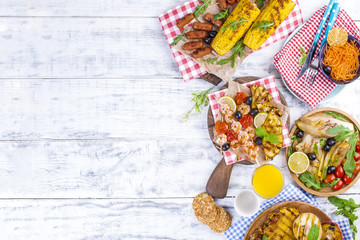 Vegetables, fruits and shrimp on the grill, for a summer lunch. Healthy food. Appetizers on a white background. Copy space. flat lay.