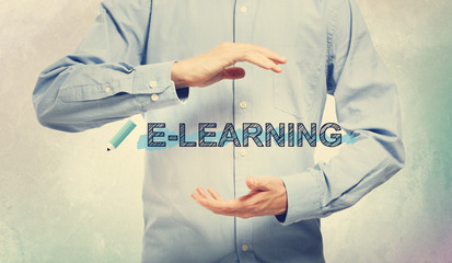 E-Learning with businessman on a soft colored wall