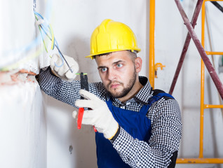 Professional builder is working with electric