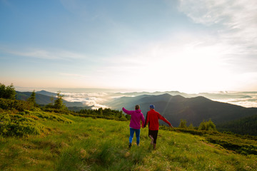 Happy couple of adventurers is running and having fun