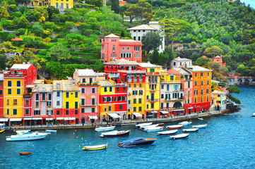 Fototapeta na wymiar The beautiful Portofino with colorful houses and villas, luxury yachts and boats in little bay harbor. Liguria, Italy, Europe