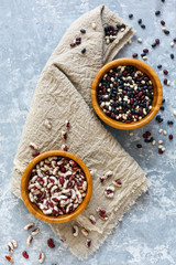 Different types of beans in wooden bowls.
