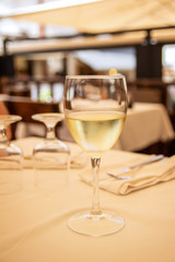 The glass of white wine in street cafe. Space for text