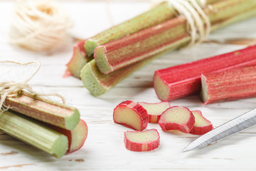 Fresh organic rhubarb on a white old wooden table