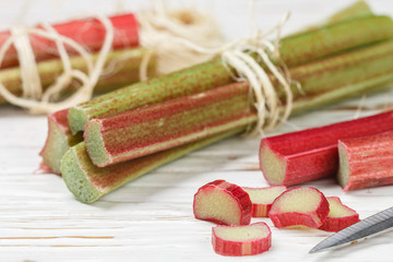 Fresh organic rhubarb on a white old wooden table