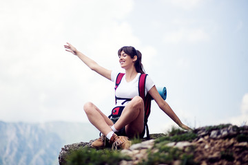 Successful female hiker enjoy the view hiking on mountain peak