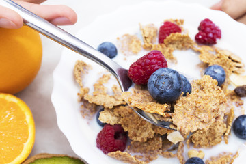 spoon with cereals and fruits, breakfast and healthy snack