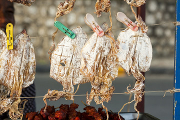 Asian street food - dried squid - close up.
