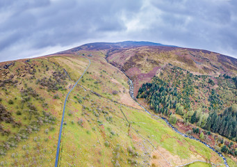 Naklejka premium Aerial view of a valley with river and waterfall in Wales - United Kingdom