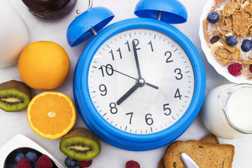 Fototapeta na wymiar breakfast time, alarm clock and healthy and balanced breakfast