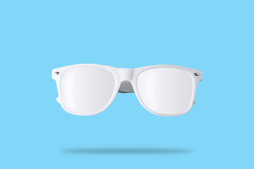 White sunglasses on pastel blue background. Minimal summer concept. Flat lay.