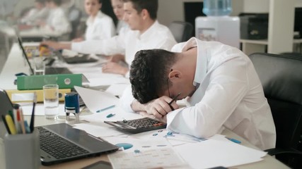 Close-up on very tired financial department employee.
